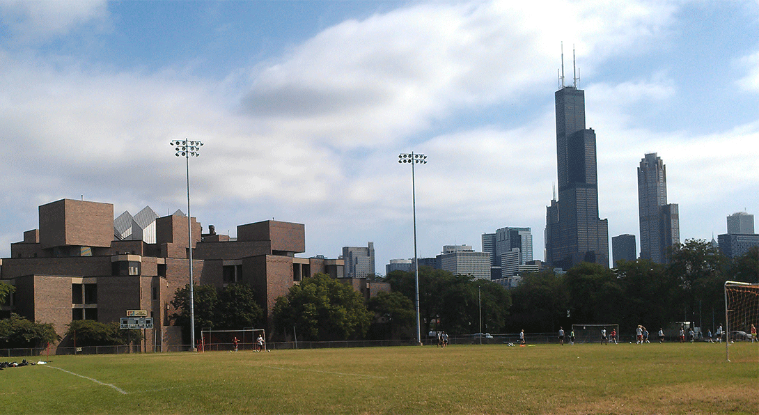 View of the Physics building with blue sky and the Willis Tower in the background